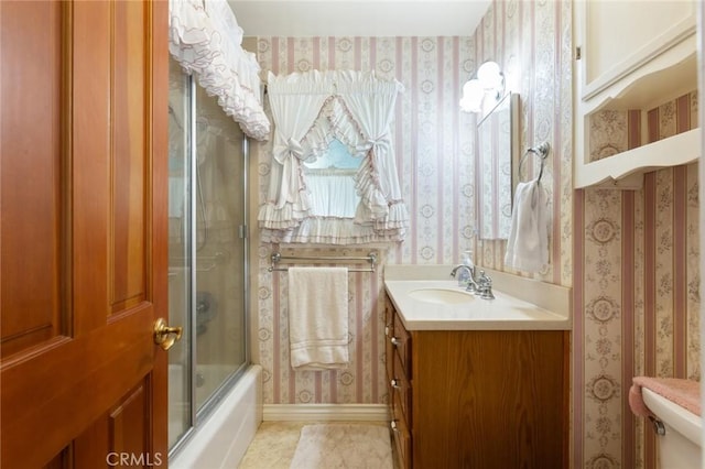 full bathroom with combined bath / shower with glass door, vanity, toilet, and tile patterned flooring