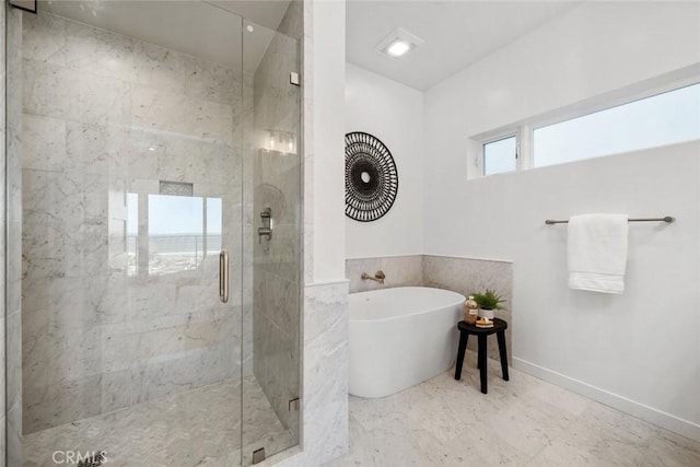 bathroom featuring separate shower and tub