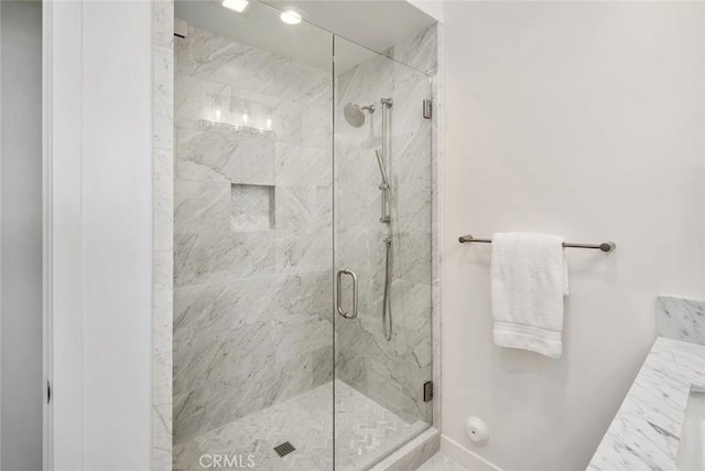 bathroom featuring a shower with shower door