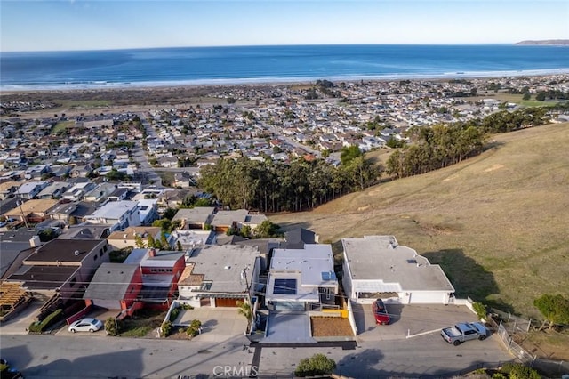 birds eye view of property with a view of the beach and a water view