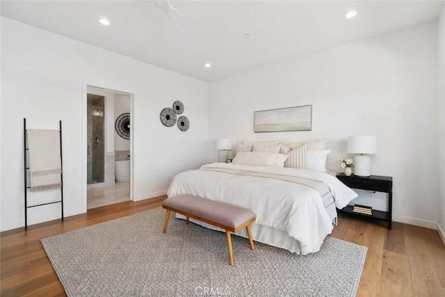 bedroom featuring light hardwood / wood-style floors and ensuite bath