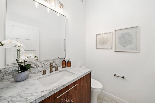 bathroom with toilet and vanity