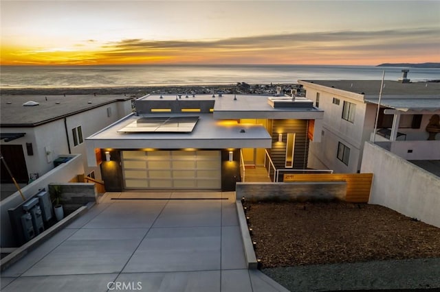 contemporary home featuring a water view and solar panels