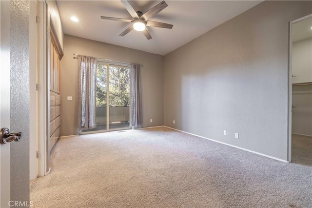 unfurnished room featuring baseboards, a ceiling fan, and carpet flooring