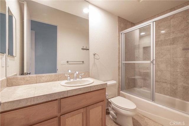 bathroom featuring shower / bath combination with glass door, vanity, and toilet