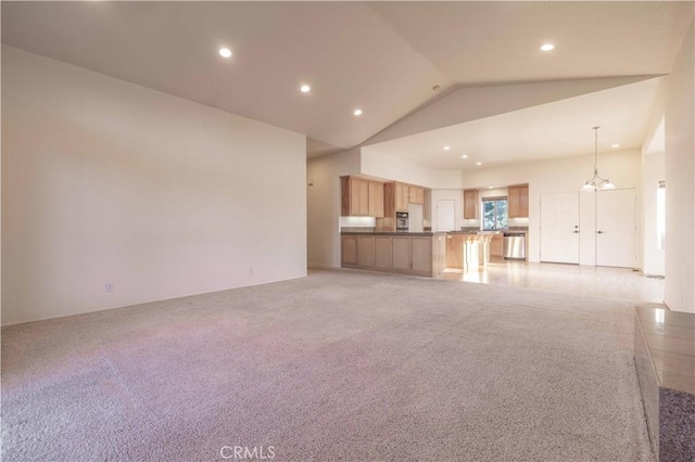 unfurnished living room featuring light carpet, high vaulted ceiling, and recessed lighting