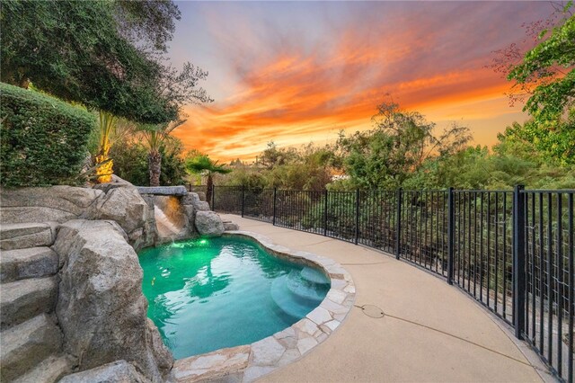 view of pool at dusk