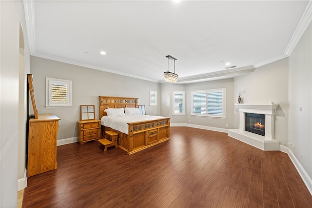 bedroom with dark hardwood / wood-style flooring and crown molding