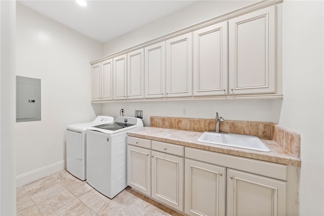 laundry area featuring cabinets, sink, washing machine and clothes dryer, and electric panel