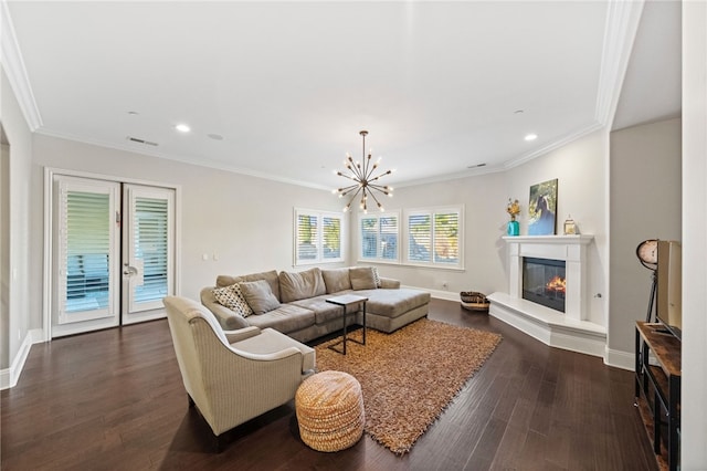 living room featuring dark hardwood / wood-style floors, crown molding, and a chandelier