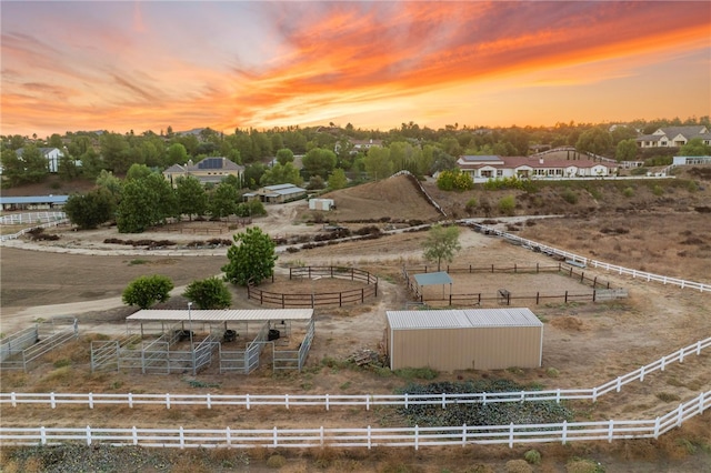 aerial view at dusk featuring a rural view