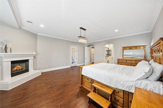 bedroom with dark hardwood / wood-style flooring and crown molding