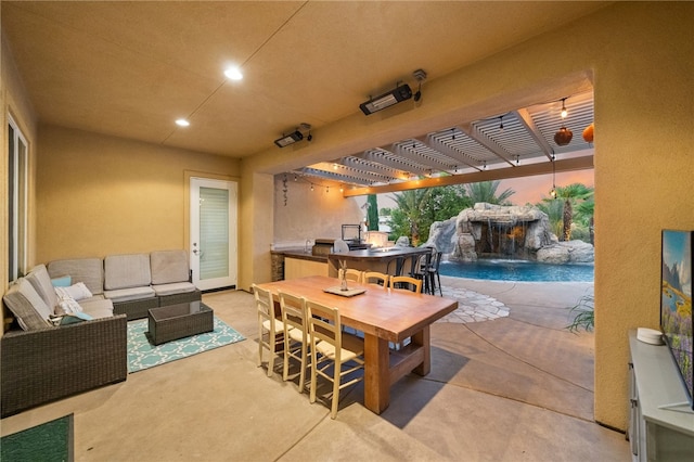 view of patio featuring an outdoor living space, pool water feature, and a pergola