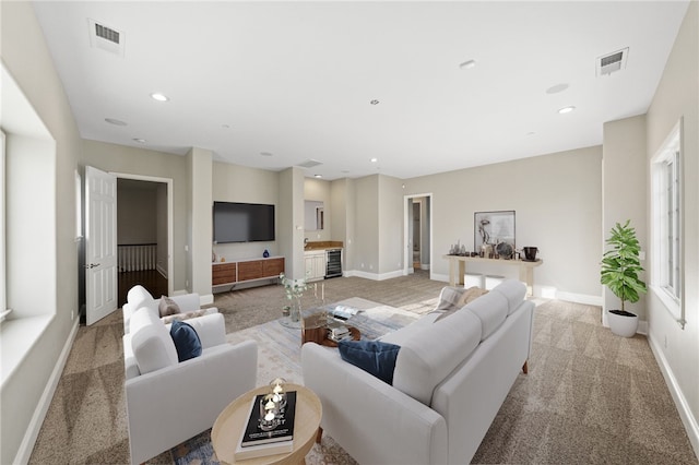 living room with light carpet and wine cooler