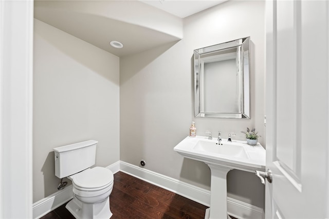 bathroom featuring wood-type flooring and toilet