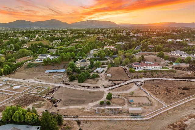 aerial view at dusk featuring a mountain view