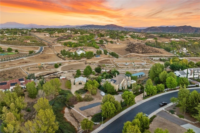 aerial view at dusk featuring a mountain view