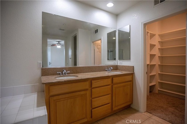 bathroom featuring ceiling fan, vanity, and tile patterned flooring