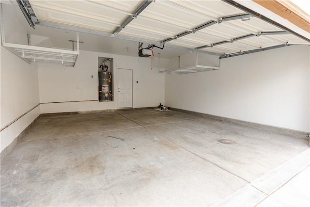 garage with water heater and a garage door opener