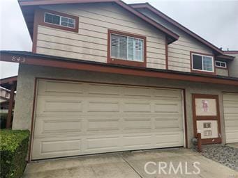 garage featuring concrete driveway