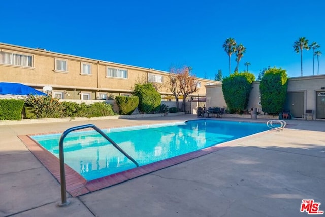 view of swimming pool with a patio area