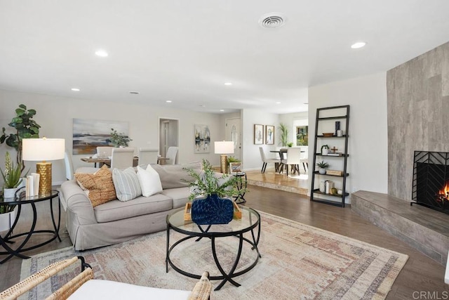 living room with hardwood / wood-style floors and a fireplace