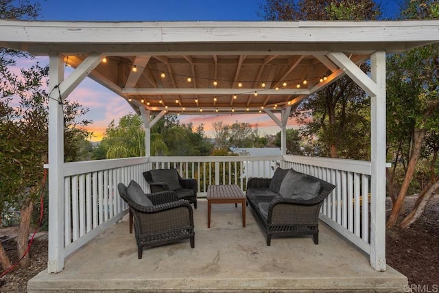 patio terrace at dusk with an outdoor living space and a gazebo