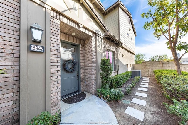 doorway to property with central AC unit