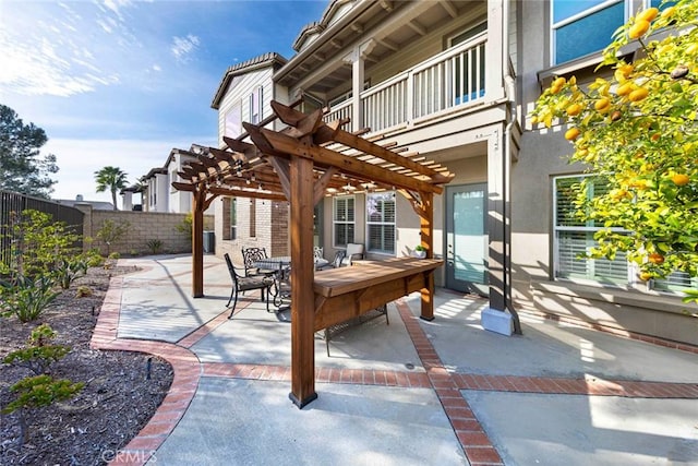 view of patio featuring a pergola, outdoor dining area, and fence