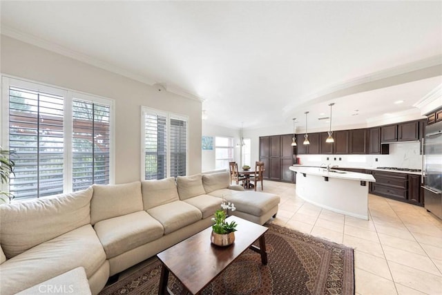 living room with light tile patterned floors and ornamental molding