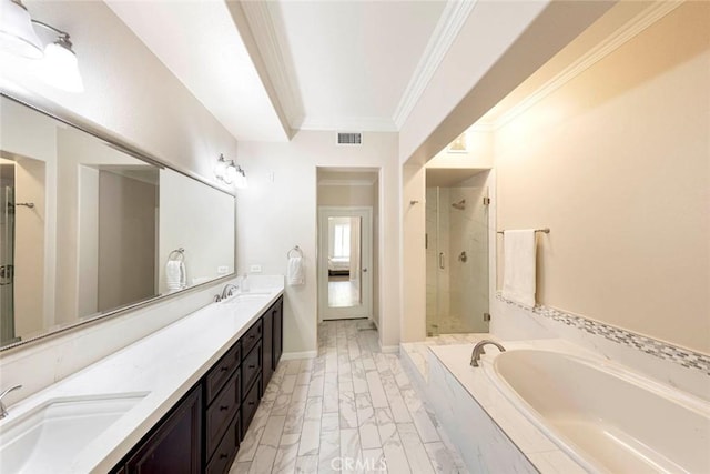 full bath with a bath, a sink, a stall shower, and crown molding