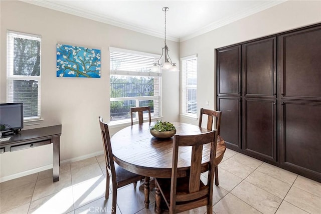 dining space featuring light tile patterned floors, crown molding, and baseboards