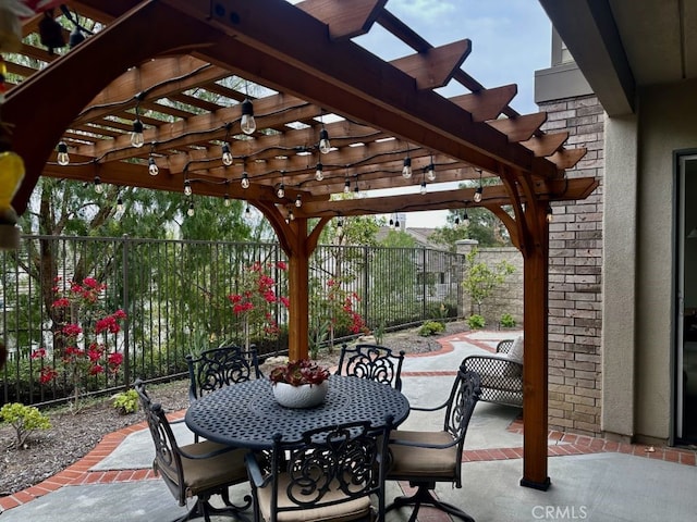 view of patio with a pergola, outdoor dining area, and fence