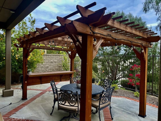 view of patio featuring a pergola, fence, and outdoor dining space