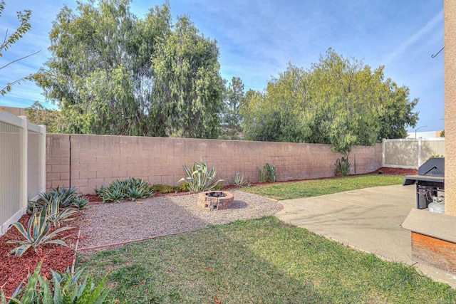 view of yard with an outdoor fire pit and a patio