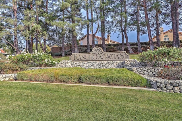 community / neighborhood sign featuring a yard