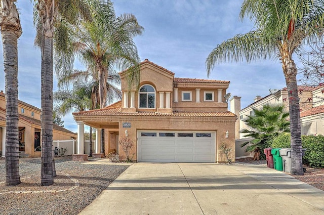 mediterranean / spanish home featuring a garage