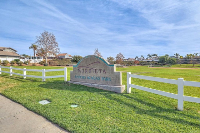 community / neighborhood sign with a lawn