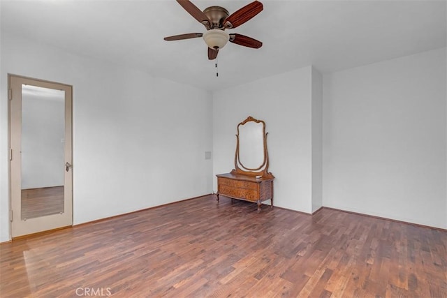 unfurnished room with ceiling fan and dark hardwood / wood-style floors