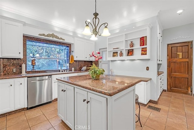 kitchen with dishwasher, dark stone countertops, pendant lighting, a center island, and white cabinetry