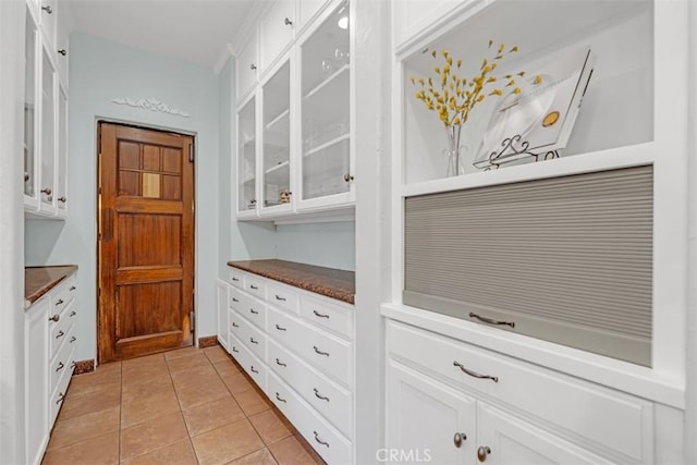 interior space with white cabinets and light tile patterned flooring