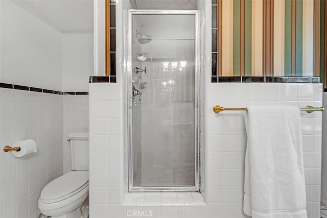 bathroom with toilet, tile walls, and walk in shower