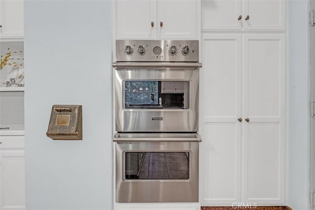 kitchen featuring white cabinets and double oven