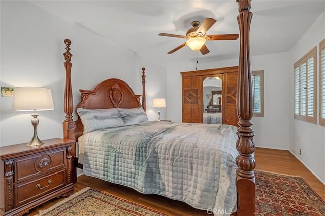 bedroom featuring ceiling fan and dark wood-type flooring