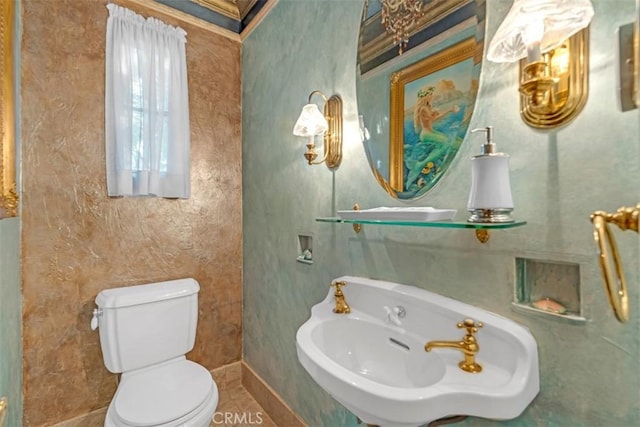 bathroom with toilet, tile patterned floors, and sink