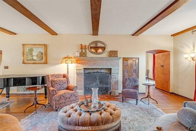 living room with light wood-type flooring and beam ceiling