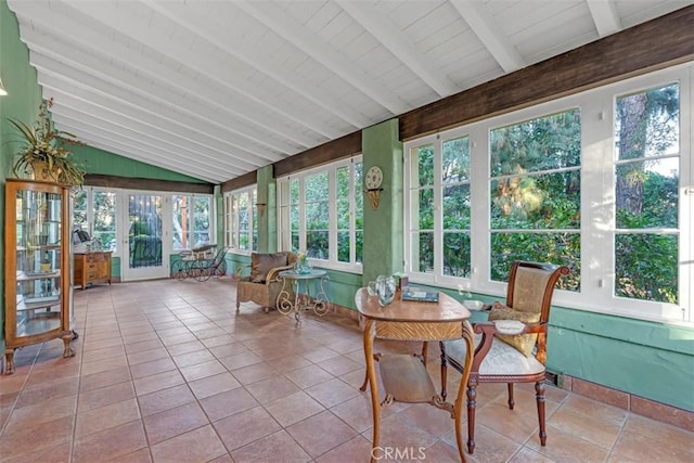 sunroom featuring vaulted ceiling with beams