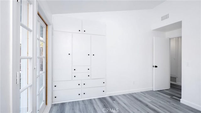 unfurnished bedroom featuring a closet and light hardwood / wood-style floors