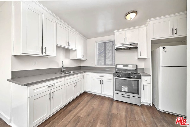 kitchen featuring white refrigerator, sink, white cabinets, and stainless steel gas range oven