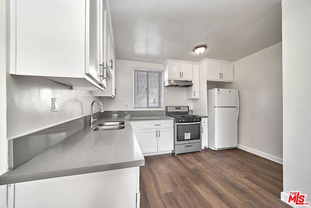 kitchen with white cabinets, white refrigerator, stainless steel gas stove, sink, and dark hardwood / wood-style floors